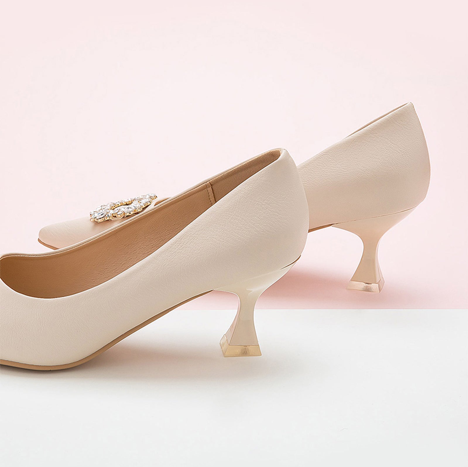  White Embellished Kitten Heel Pumps featuring a decorative buckle, a chic and modern choice for everyday wear
