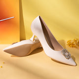 Effortless Elegance: Embellished White Kitten Heel Pumps with a stylish buckle, featuring refined details for a polished and sophisticated style