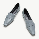 Blue platform loafers with penny strap detail.