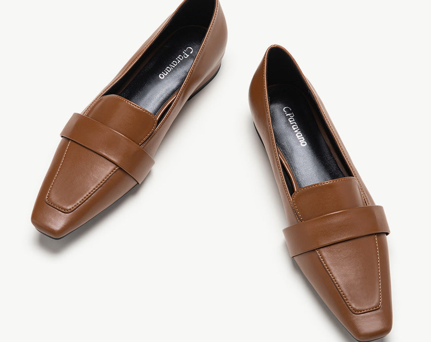 Brown platform loafers with penny strap detail.