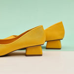 Step into sophistication with these yellow classic pumps featuring a comfortable block heel, perfect for adding a pop of color to your refined look.