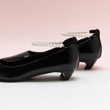 Black Low Heel with delicate pearl straps, adding a subtle yet elegant touch to your ensemble