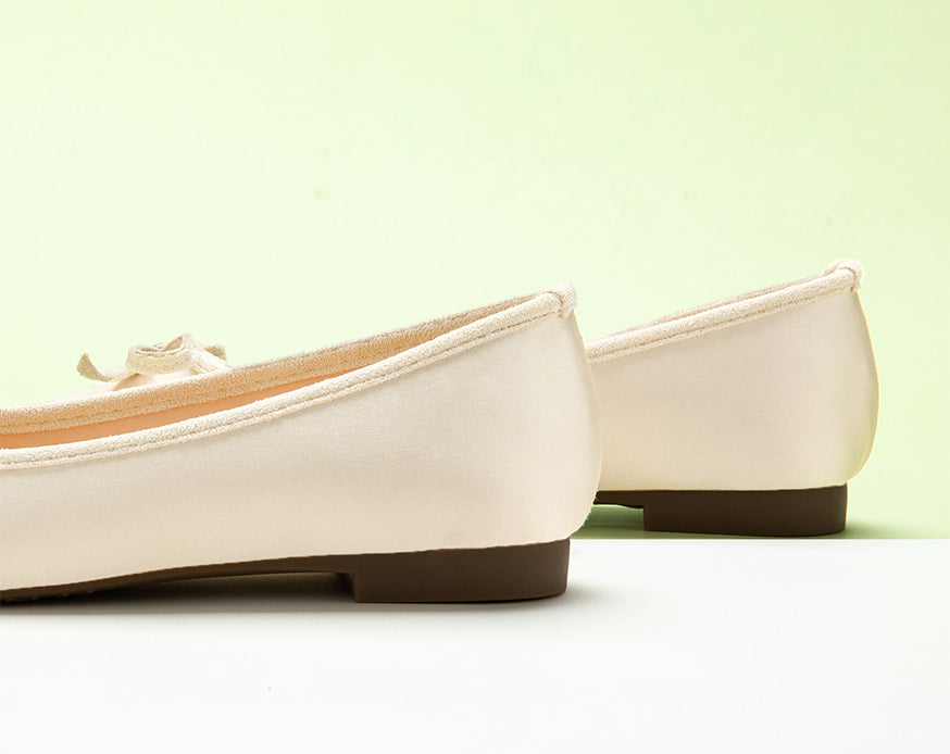 Chic-silky-ivory-ballet-flats-with-a-delicate-bowknot-accent_-adding-a-touch-of-grace.