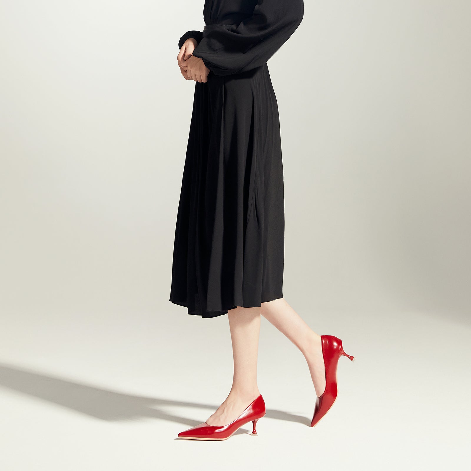 Bold and Beautiful: Red Glossed Patent Leather Pumps, adding a touch of modernity to your ensemble in a striking hue