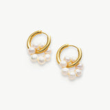 Tunnel Hoop Earrings adorned with delicate seed pearls, an elegant and timeless accessory that adds a touch of sophistication to your ensemble