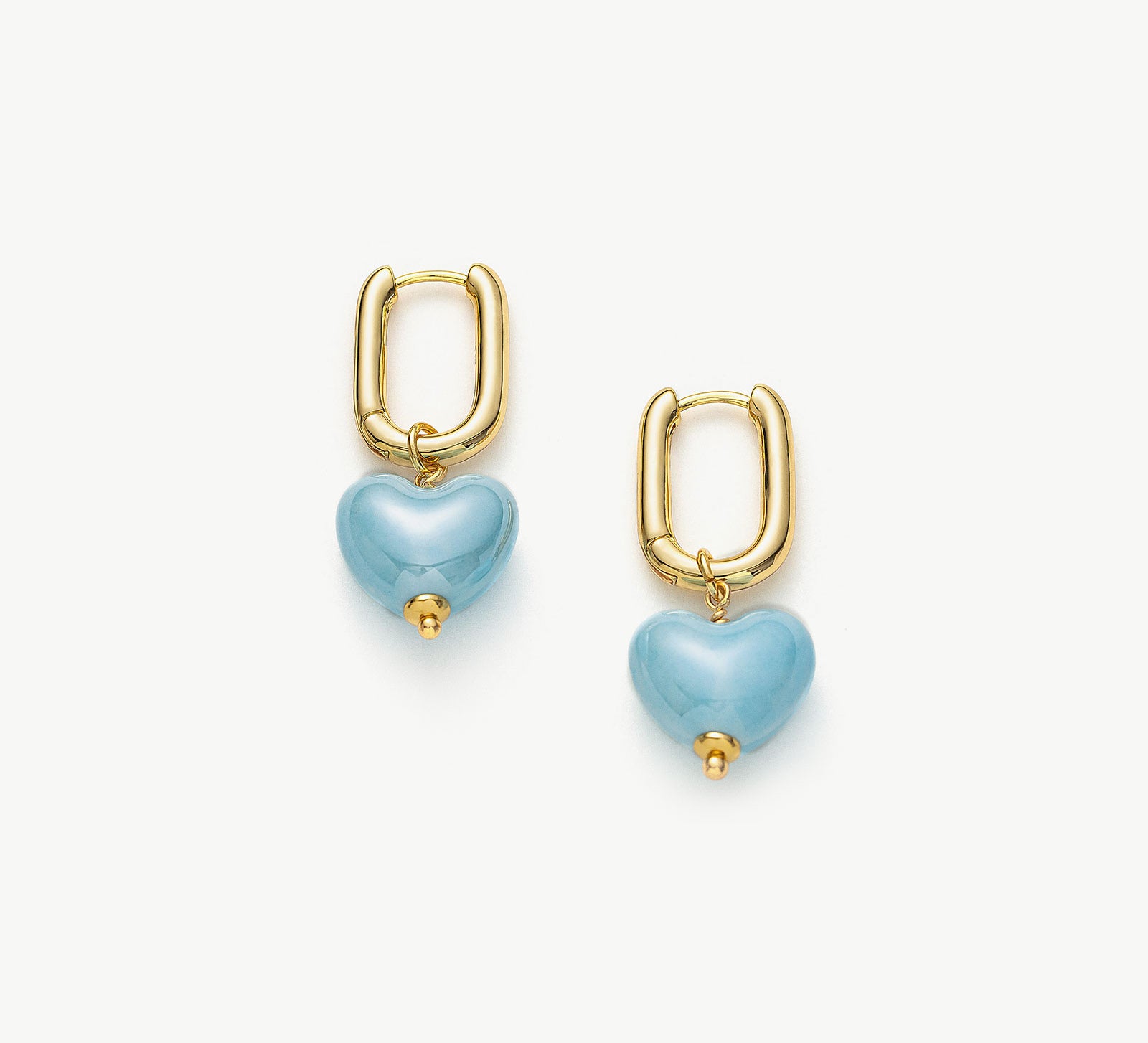  Ceramics Heart Hoop Earrings in Blue, a charming and ceramic accessory that features heart-shaped hoops in a serene and captivating cerulean blue hue