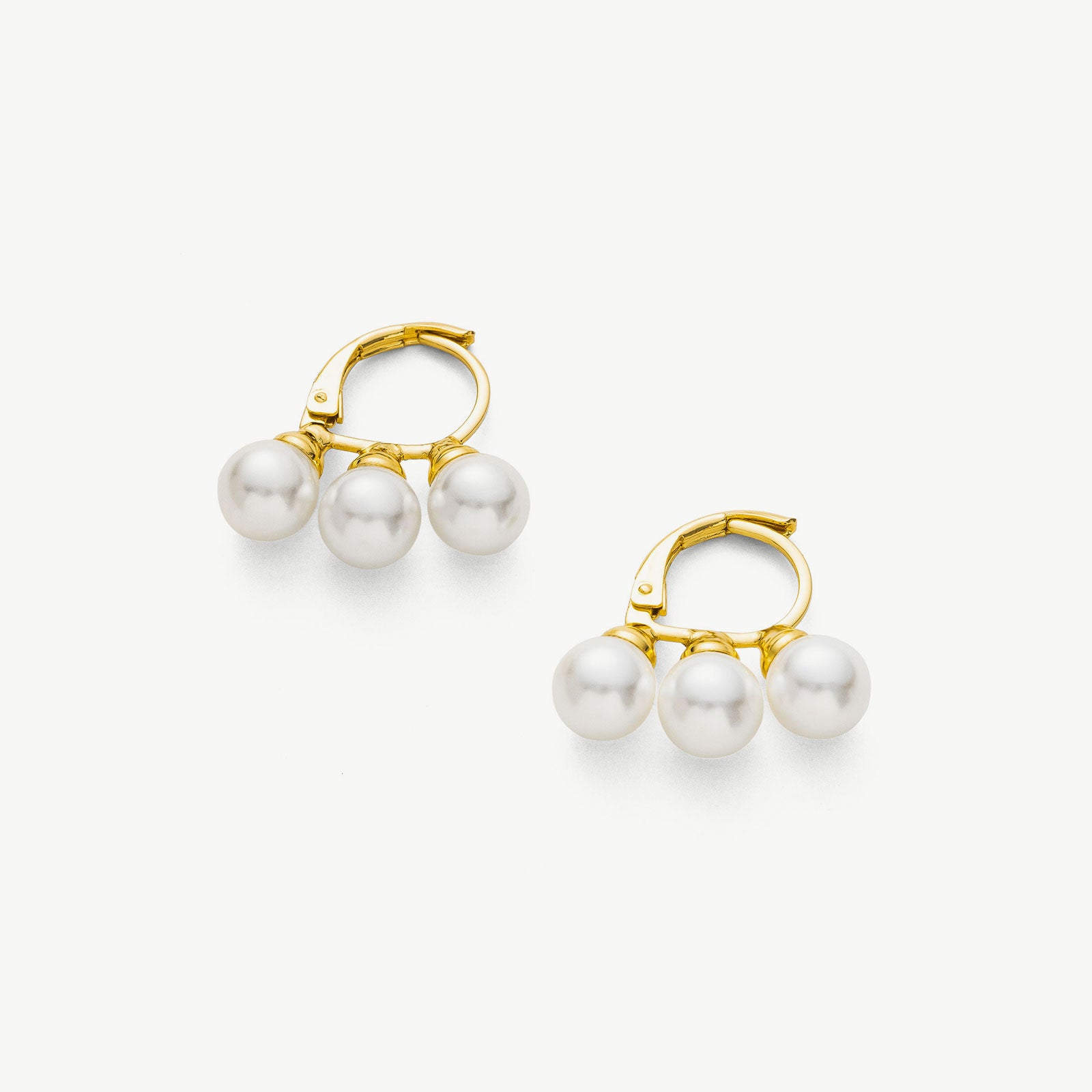 Pearl Huggies in Gold, a captivating and elegant pair of huggie earrings featuring lustrous pearls embraced by a warm and radiant golden setting