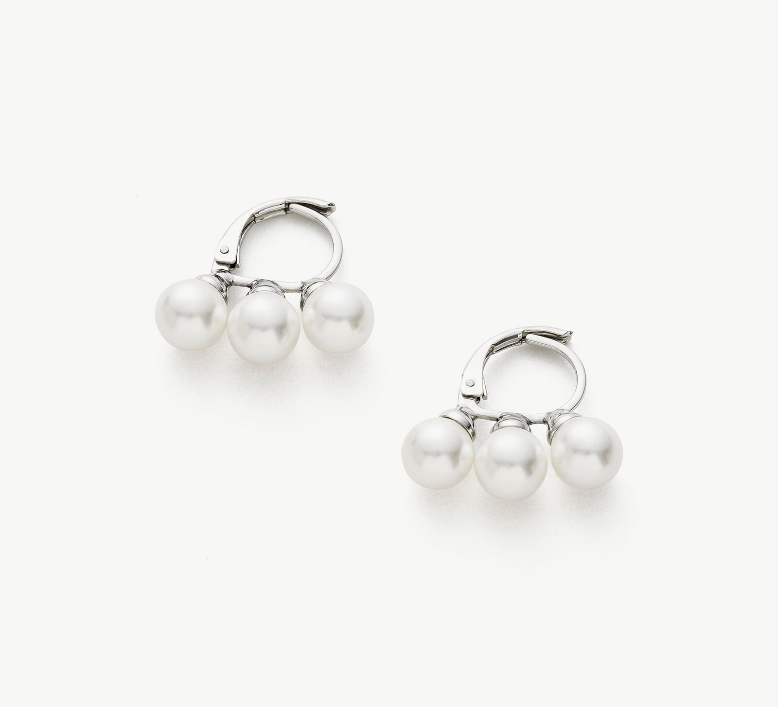 Pearl Huggies in Silver, a graceful and enchanting pair of huggie earrings featuring lustrous pearls embraced by a cool and silver setting