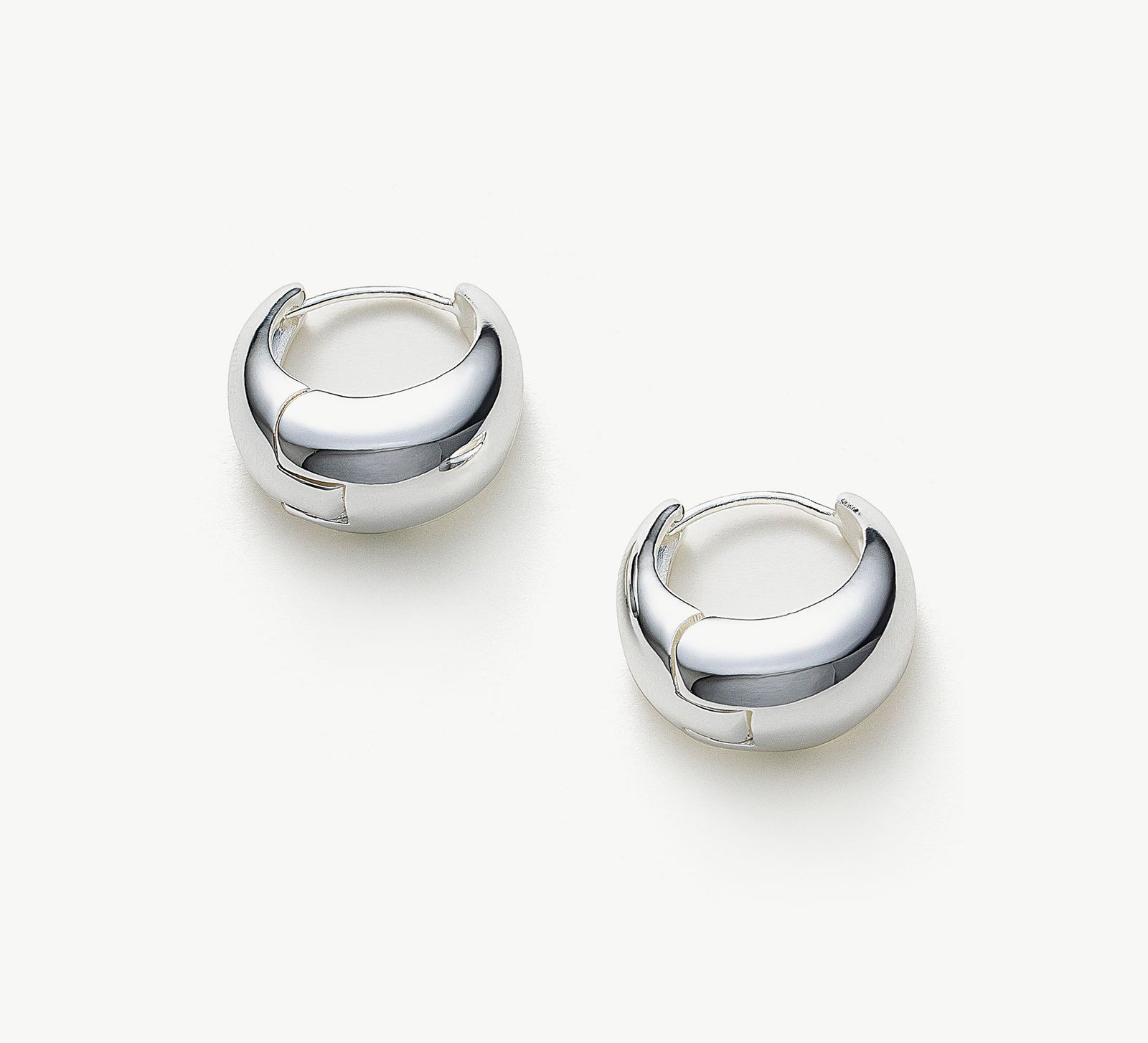  Dome Hoop Earrings in Silver, a sleek and sophisticated pair that adds a touch of modern elegance to your ears.