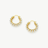 Medium Pearl Huggie Earrings, featuring a medium-sized design that gently hugs the ear, these earrings exude elegance with their lustrous pearl accents
