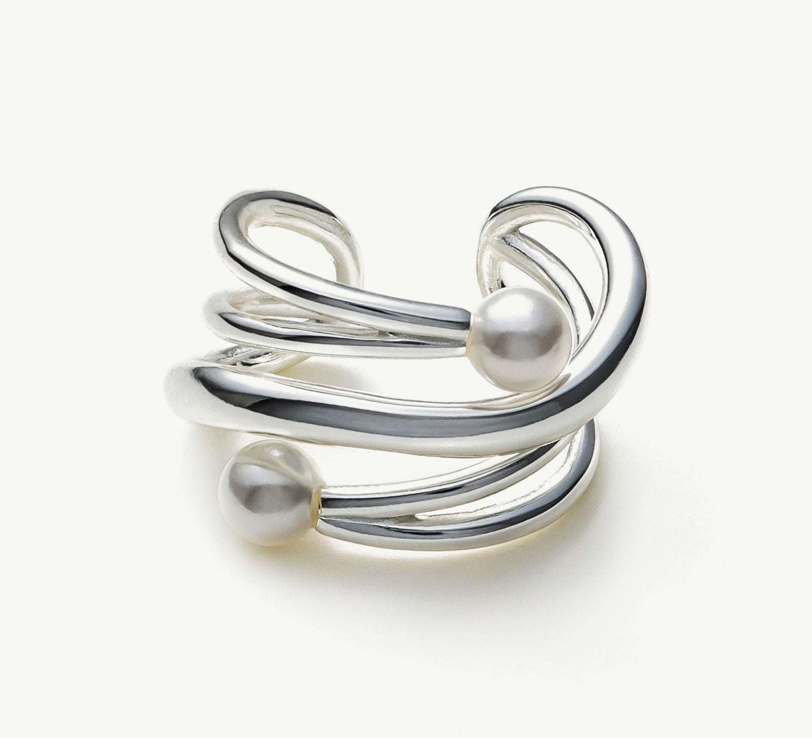 Silver Claw Pearl Ear Cuff, a sleek and modern accessory that adds a touch of contemporary elegance to your ear