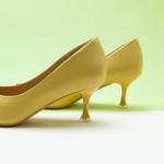 Radiant Yellow Shine: Yellow Women Pumps featuring geometric patterns, combining comfort with a bold and fashionable flair