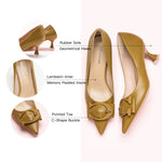 Make a chic statement with these pumps showcasing a kitten heel and a delicate buckle in a straw color, adding a touch of modern comfort to your ensemble