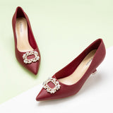 Red Carpet Ready: Embellished Red Kitten Heel Pumps featuring a decorative buckle, a glamorous choice for special occasions