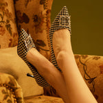 ophisticated Patterns: Houndstooth Tweed Pumps with an embellished square buckle, blending classic and contemporary styles