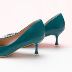 Chic and luxurious peacock blue pumps with a sparkling crystal buckle