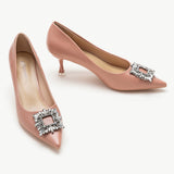 Pink leather pumps with a glamorous crystal buckle embellishment