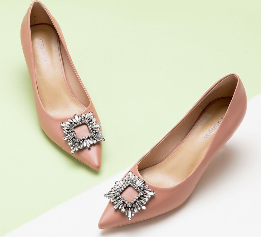 Elegant pink high heels adorned with a sparkling crystal buckle.