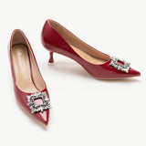 Red leather pumps with a captivating crystal buckle embellishment