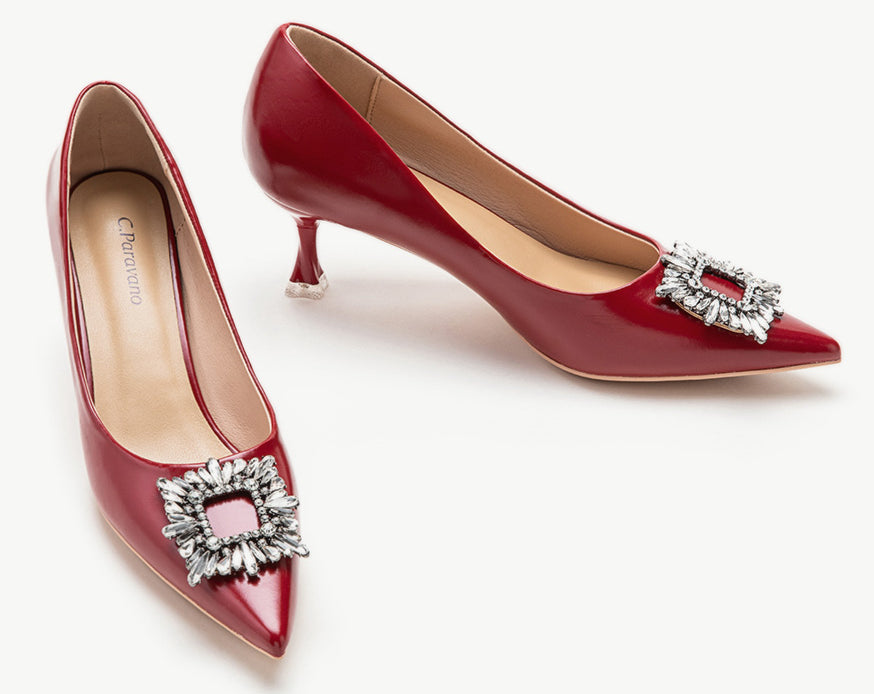 Red leather pumps with a captivating crystal buckle embellishment