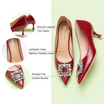 Gorgeous leather pumps in vibrant red, complemented by a crystal buckle.