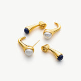 Crossover Hoop Earrings featuring classic pearls with a modern twist, creating a stylish and versatile accessory for any occasion.