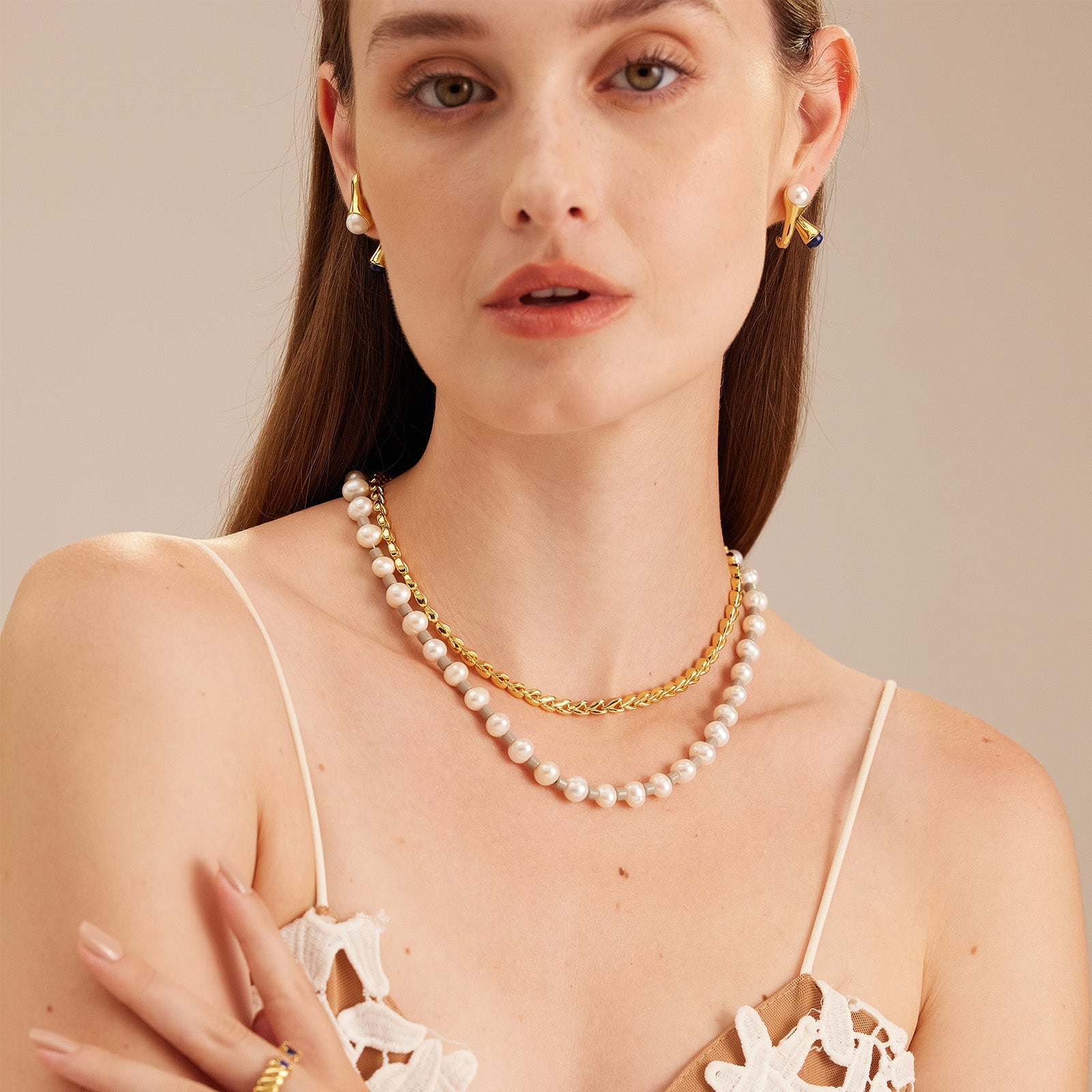 Crossover Hoop Earrings adorned with pearls, a sculptural and pearlescent creation that adds sophistication and charm to your ensemble.