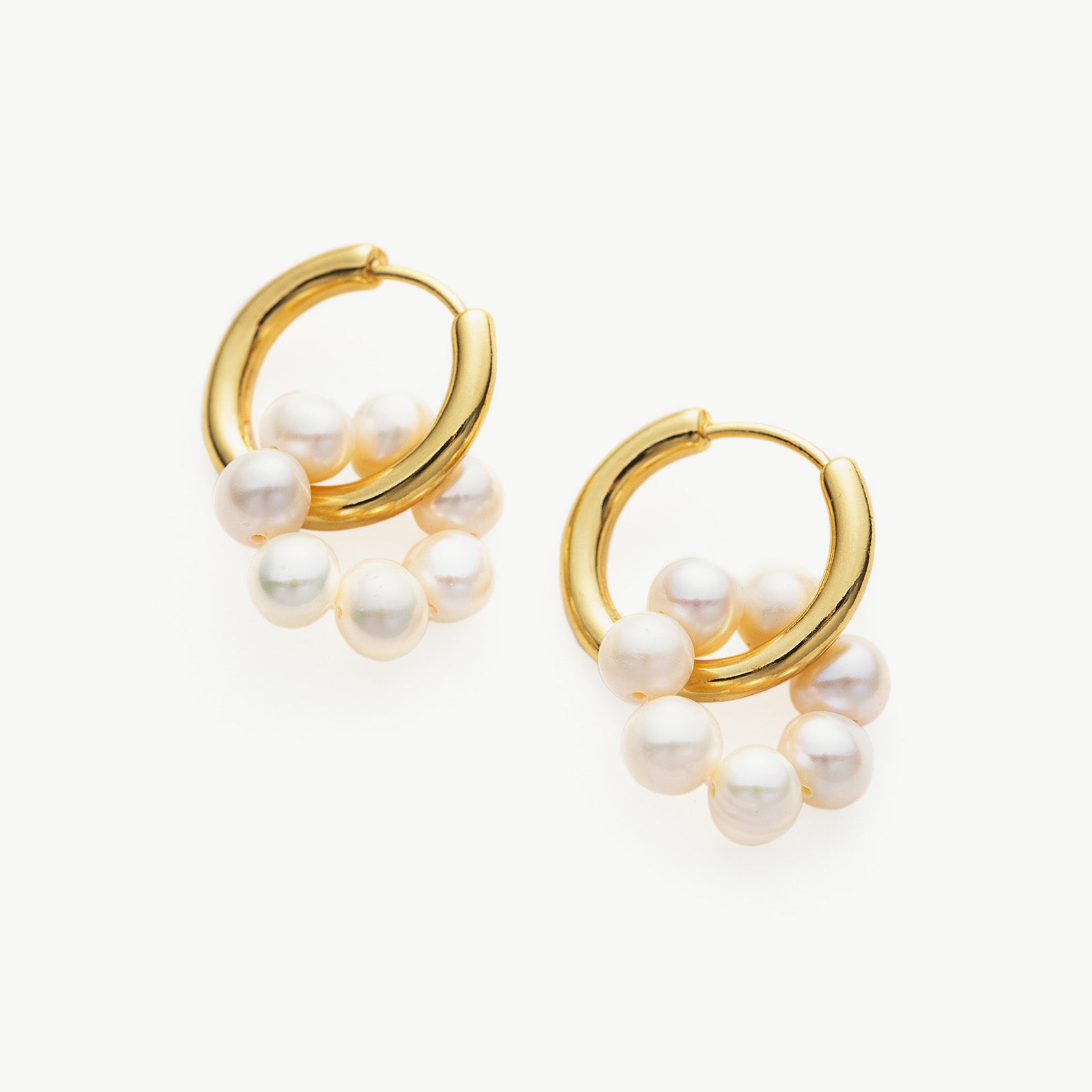 Tunnel Hoop Earrings with Seed Pearls, a chic and pearlescent twist on classic hoops, adding a touch of modern elegance to your style