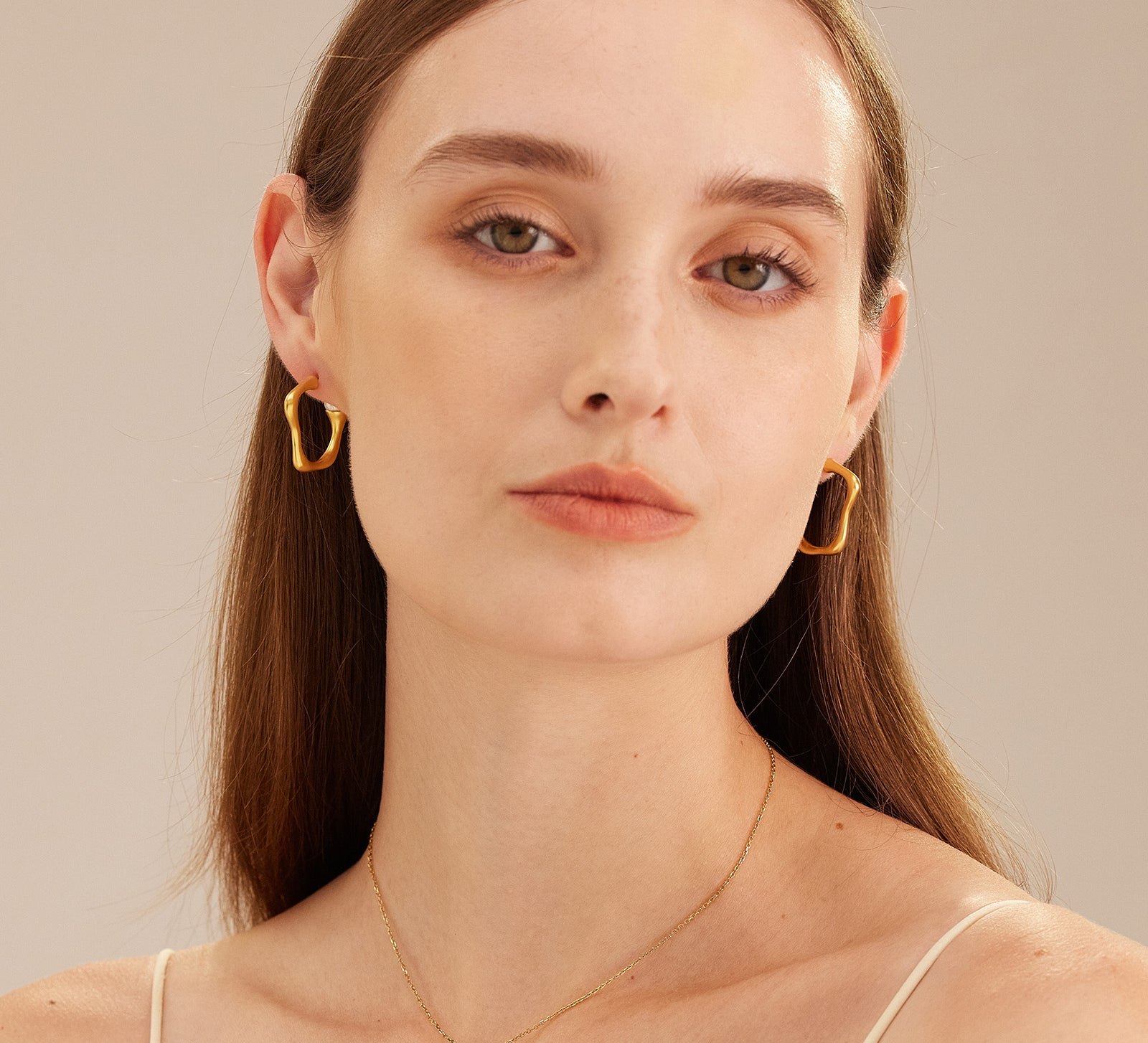 Squiggle Wavy Large Hoop Earrings, a glamorous and stylish accessory that adds a playful twist to the classic hoop design.