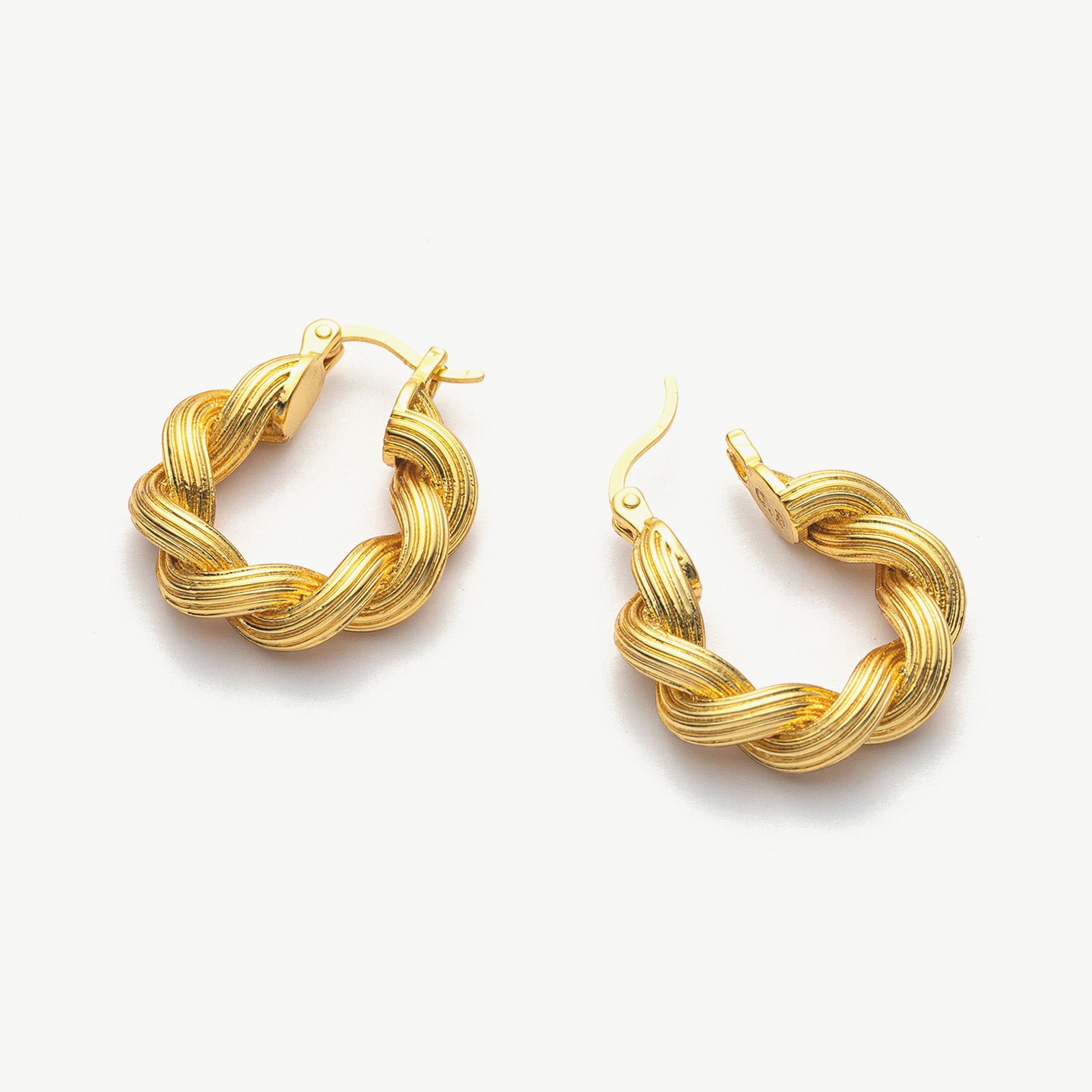 Double Rope Hoop Earrings, featuring sophisticated loops of rope, these hoops provide a refined and timeless addition to your ear jewelry collection