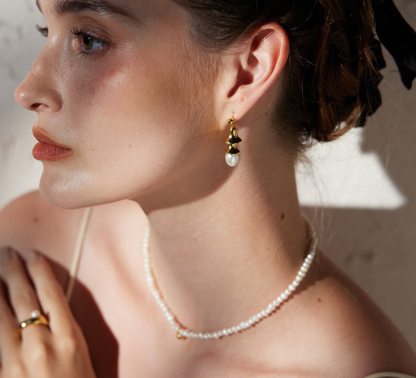 Pearl Drop Earrings in Gold featuring classic pearl adornments and golden accents, these earrings offer a versatile and stylish accessory that complements any outfit with grace.