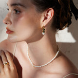 Pearl Drop Earrings in Gold featuring classic pearl adornments and golden accents, these earrings offer a versatile and stylish accessory that complements any outfit with grace.