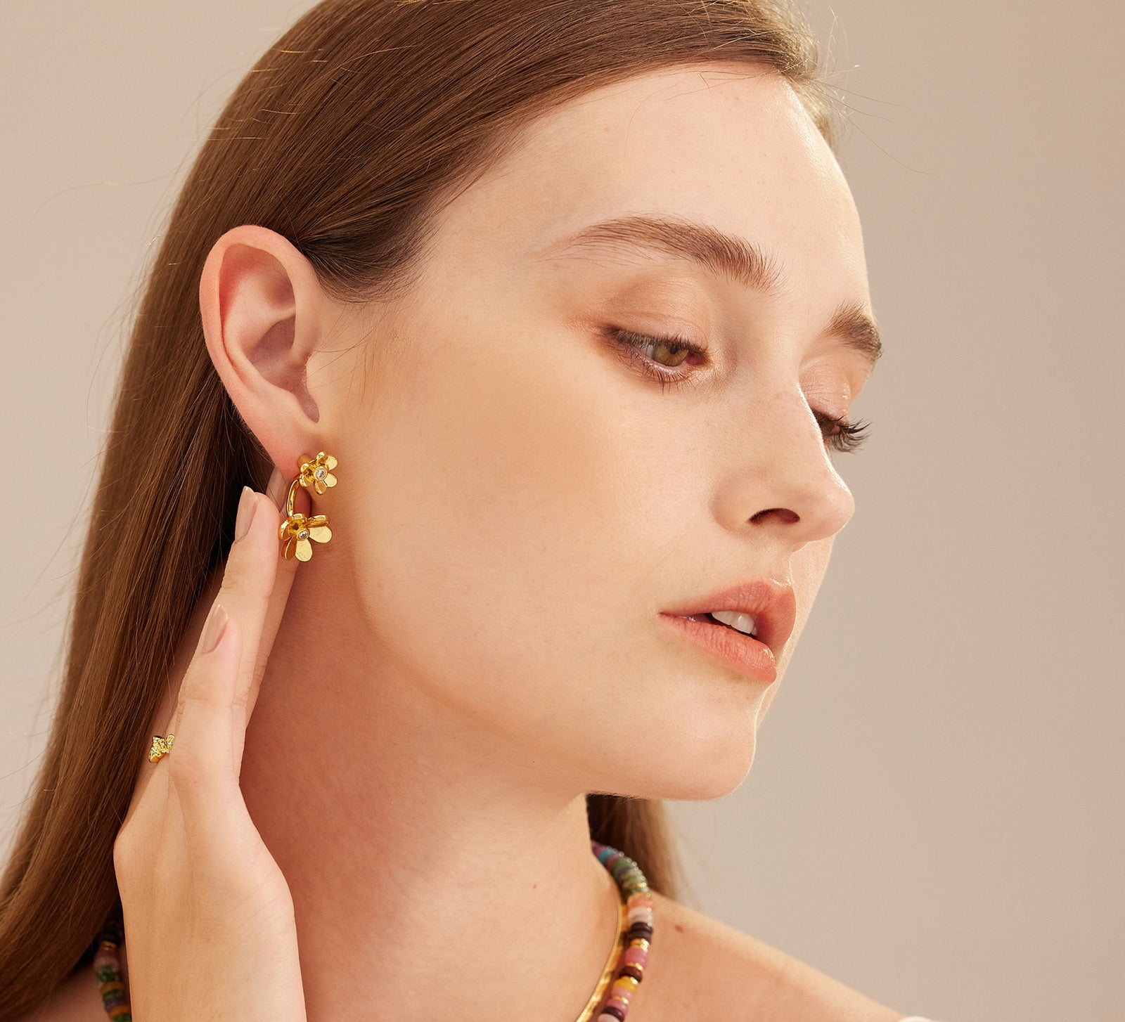 Hoop Earrings adorned with double flower charms, a stylish and elegant choice that adds a feminine and sophisticated flair to your look