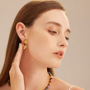 Hoop Earrings adorned with double flower charms, a stylish and elegant choice that adds a feminine and sophisticated flair to your look