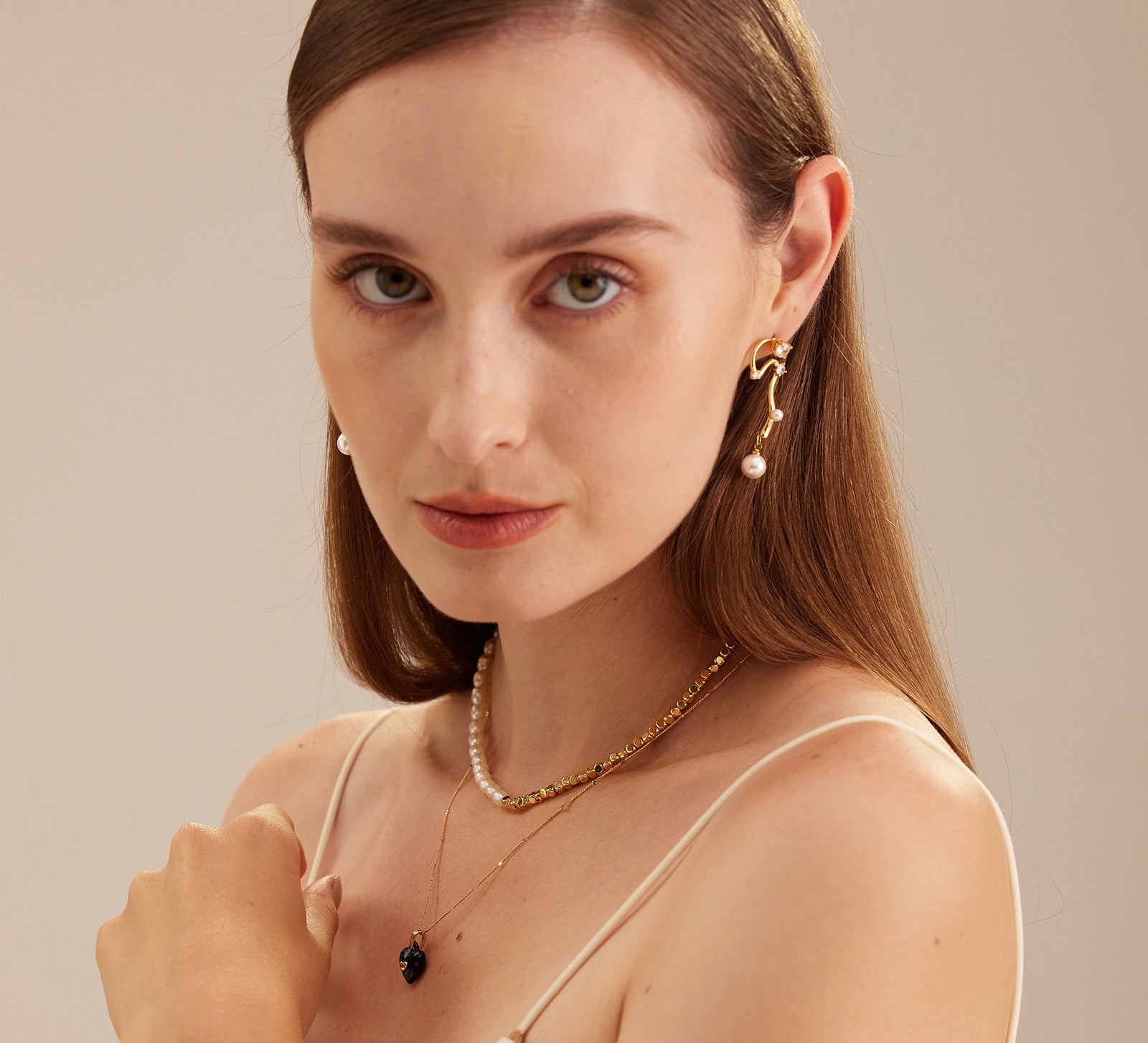 Serpent-Inspired Pearl Drop Earrings, featuring a unique twist with serpent motifs, these earrings add a touch of mystique and timeless beauty to your ensemble