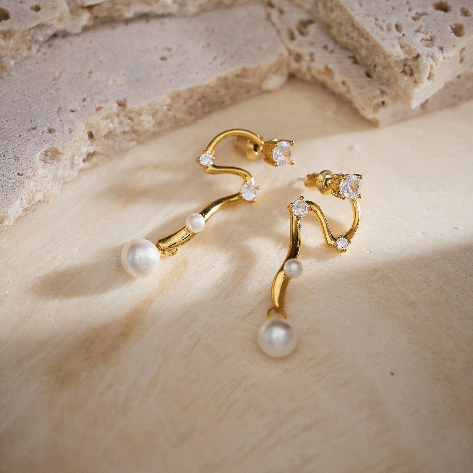 Serpent Pearl Drop Earrings, the serpentine embrace adds a hint of allure to these earrings, creating a captivating and enchanting accessory for a glamorous look