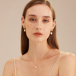 Molten Baroque Pearl Drop Earrings, showcasing the beauty of baroque pearls suspended from molten metal elements, these earrings offer a unique and artistic charm, perfect for a statement accessory.