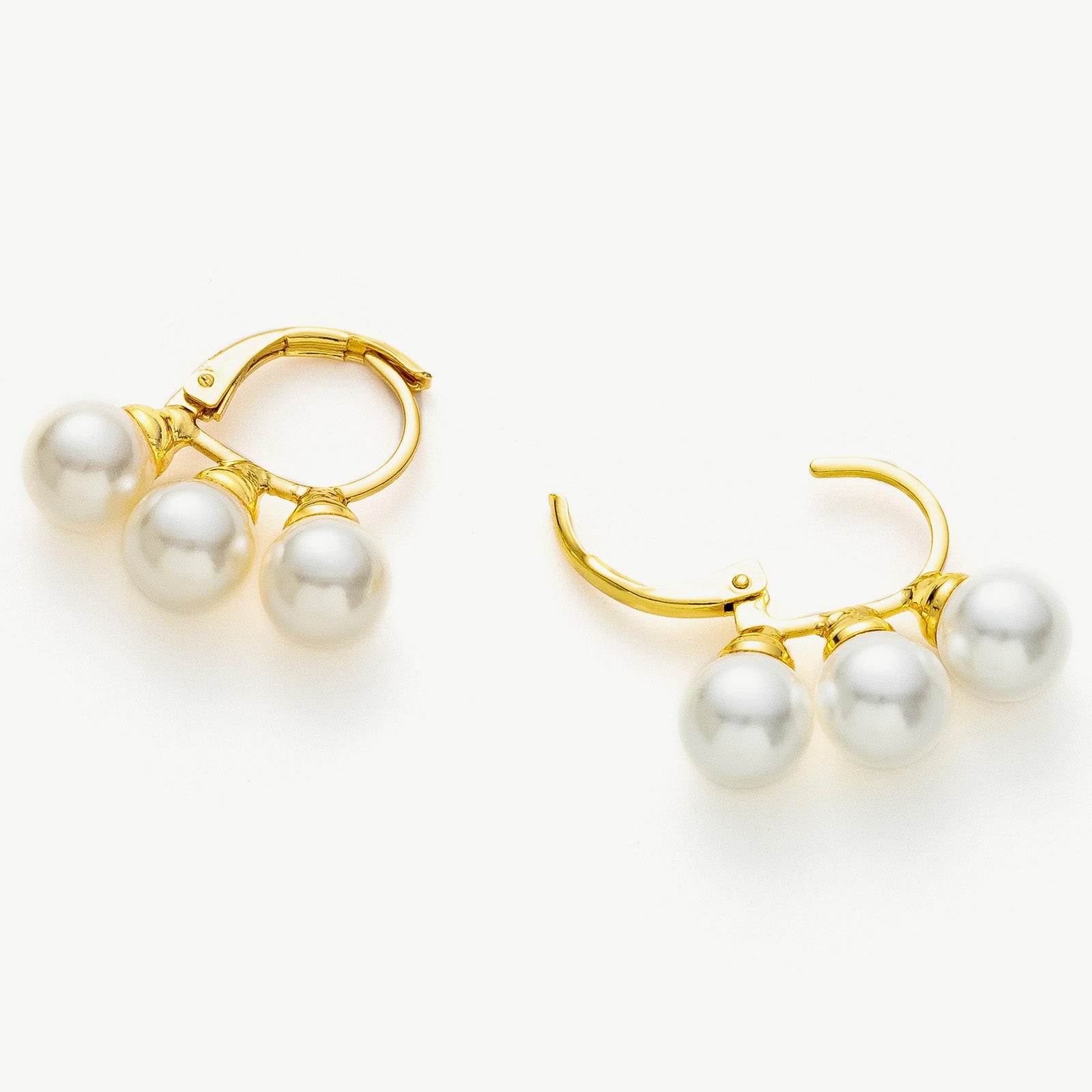 Pearl Huggie Earrings in Gold, offering chic and stylish adornments that effortlessly elevate your ear ensemble with pearls and golden charm
