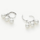Pearl Huggie Earrings in Silver, showcasing moonlit elegance with pearls nestled within a silver hoop, adding a touch of sophistication to your ears