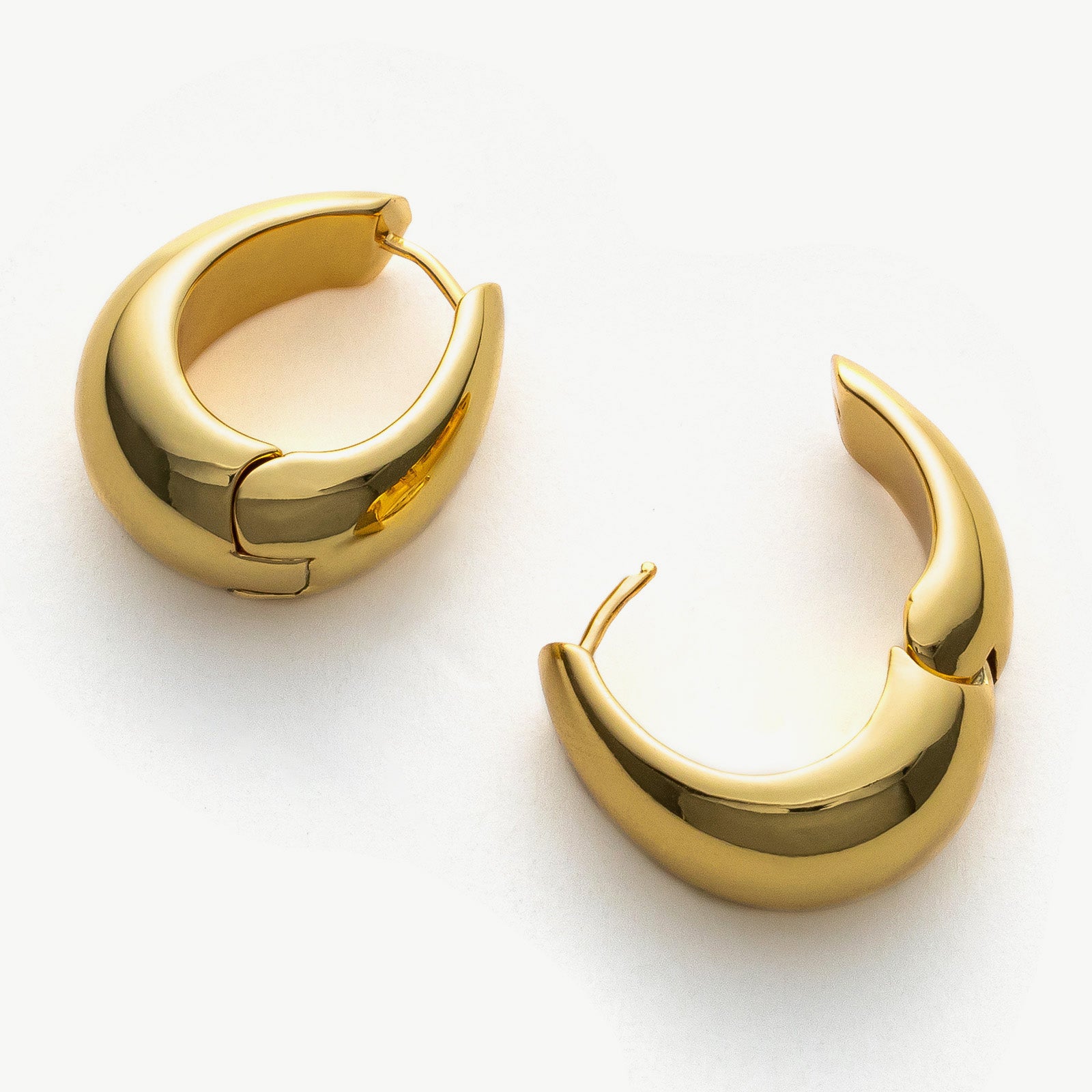 Dome-shaped Hoop Earrings in Gold, adding a touch of golden glamour to your ensemble with their bold and eye-catching design