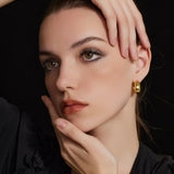  Dome Hoop Earrings in Gold, a chic and shiny accessory that effortlessly elevates your style with a touch of modern glamour
