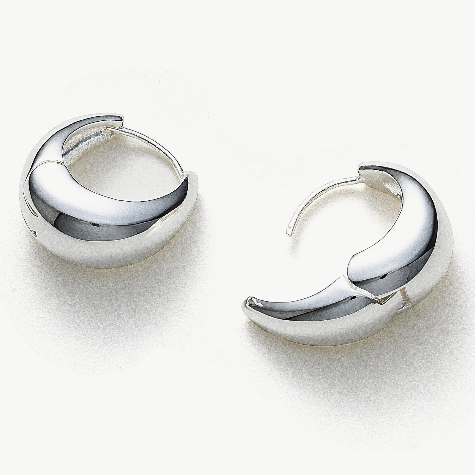  Dome Hoop Earrings in Silver, a contemporary and shiny choice that effortlessly elevates your everyday or evening look