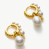 Gold Pearl Huggie Hoops creating an elegant circlet of pearls, blending the richness of gold with the timeless beauty of pearls for a refined and stylish look