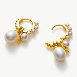 Pearl Huggie Hoops in Gold, embodying regal elegance with pearls set against a golden embrace, creating a sophisticated and majestic accessory.