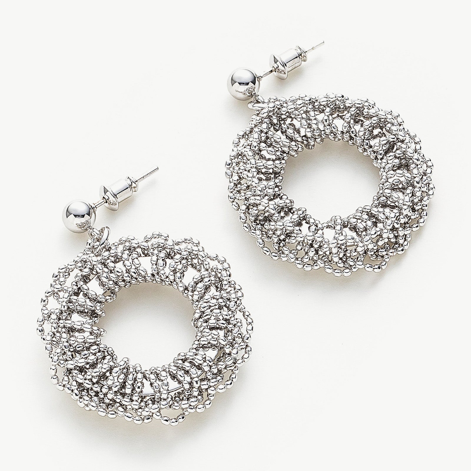 Flower Entwine Earrings with sculpted petal accents, these hoops provide a unique and artistic charm, capturing attention with their intricate floral details and sculptural beauty.