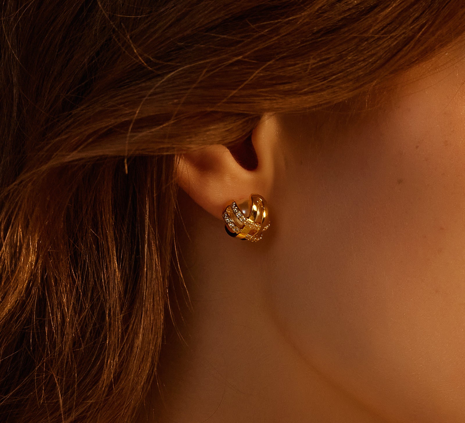 Intricately designed Coiled Stud Earrings adorned with pearls, adding a touch of modern charm to your ears
