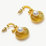 Pearl Shell Hoops, embodying coastal chic with pearls embraced by sculpted shell accents, these earrings offer a stylish and trendy accessory reminiscent of the beachside allure