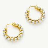 Medium Pearl Huggie Earrings with sculpted details, these hoops offer a unique and artistic charm, combining sculptural elements with the classic beauty of pearls.