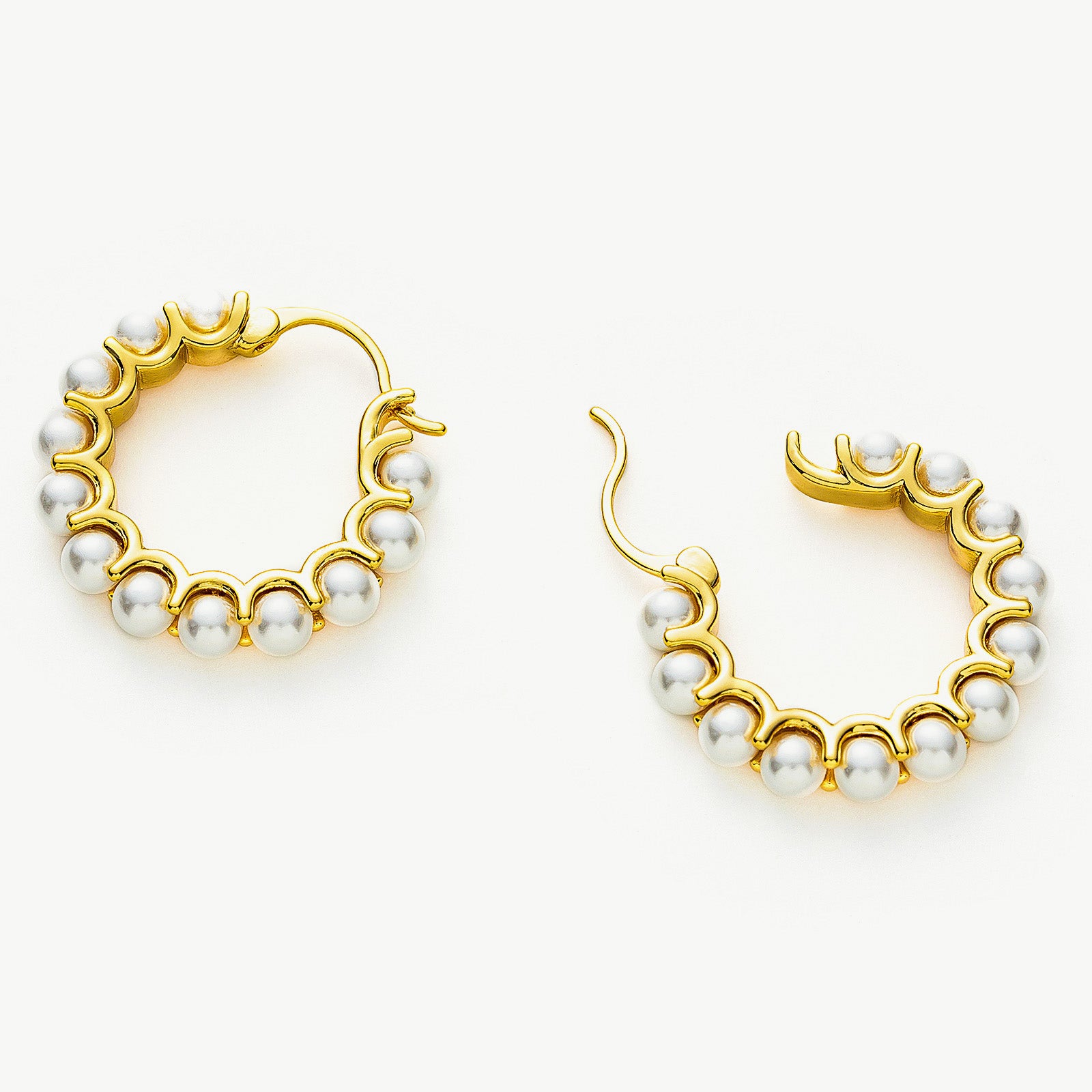 Medium Pearl Huggie Earrings creating timeless loops of pearl charm, these earrings offer a classic and versatile accessory that complements any outfit with grace