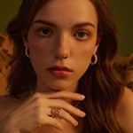  Medium Pearl Huggie Earrings creating chic circlets around the ear, these hoops provide a fashionable and versatile accessory that complements any ensemble.